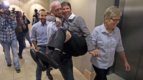From left, plaintiffs Moudi Sbeity; his partner, Derek Kitchen; Kody Partridge; and Partridge's wife, Laurie Wood, celebrate after a news conference in Salt Lake City on October 6, 2014. The U.S. Supreme Court cleared the way for same-sex marriage in Utah when it declined to hear the state's appeal of a lower court ruling. 