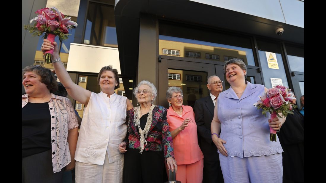 Mary Bishop, second from left, and Sharon Baldwin, right, celebrate with family and friends following their wedding ceremony on the courthouse steps in Tulsa, Oklahoma, on October 6, 2014.