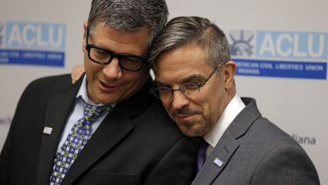 Rob MacPherson, right, and his husband, Steven Stolen, hug during a news conference at the American Civil Liberties Union in Indianapolis on October 6, 2014.
