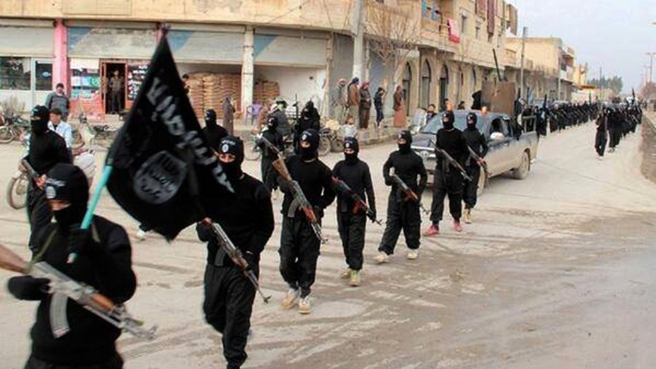 [File] This undated file image posted on a militant website on January 14, 2014 shows ISIS fighters marching through Raqqa, Syria.