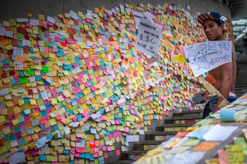 Post-it messages filled with sketches and messages cover a wall next to a stairway in the Admiralty district in Hong Kong. Some of them are words of hope, and others denounce the Hong Kong's top official, the chief executive. 