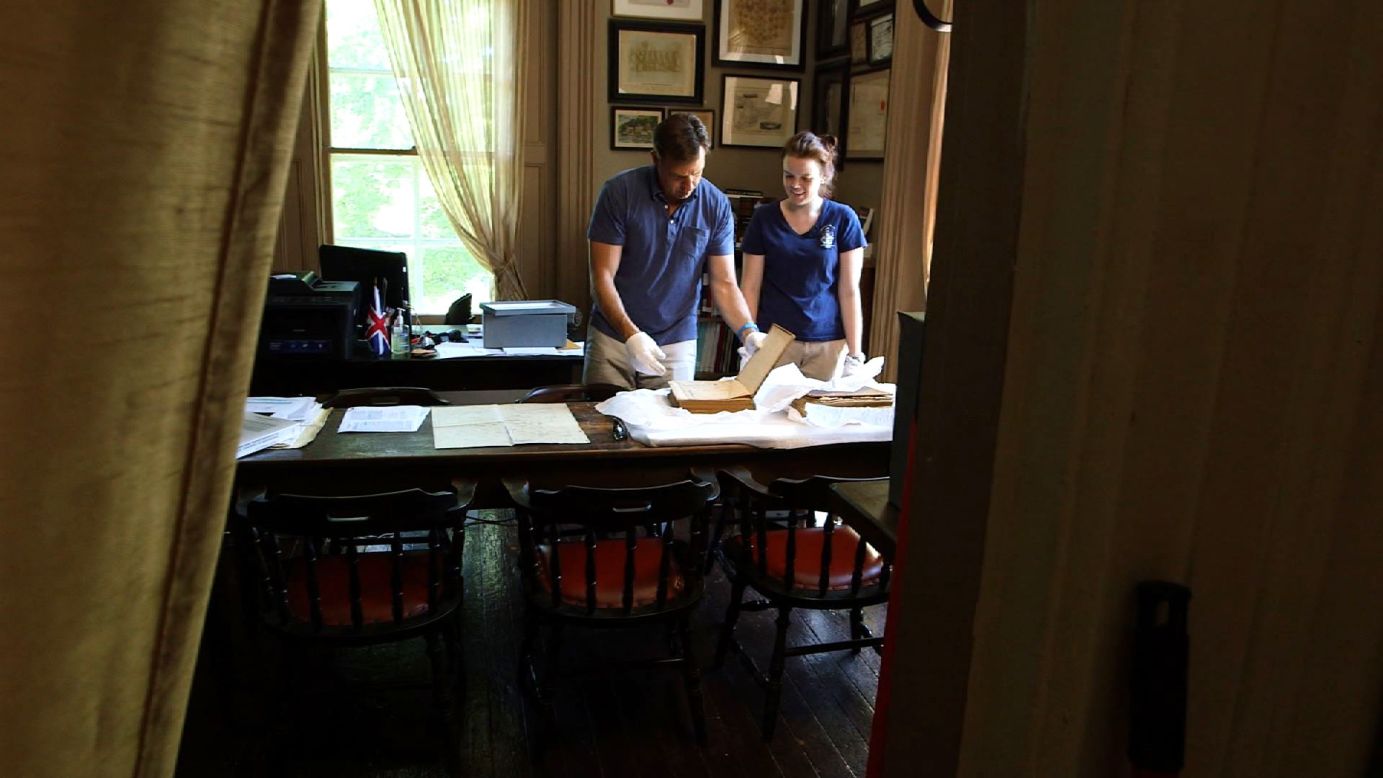 Tapper examines a Huff family Bible from the 1800s along with Christine Smith, a librarian at the United Empire Loyalist Heritage Museum.