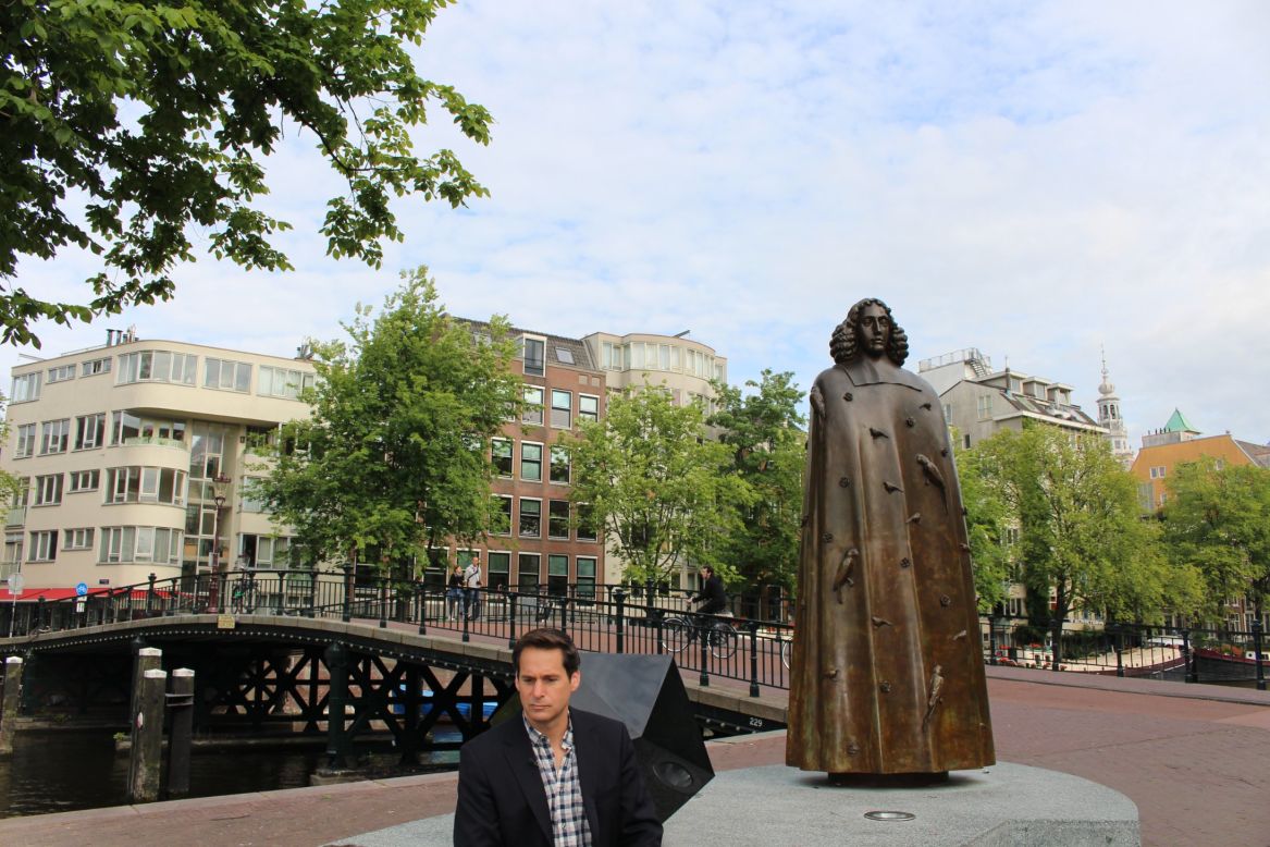 Berman reveals his mission to find his "inner Spinoza" while sitting next the statue honoring the Dutch philosopher in Amsterdam.