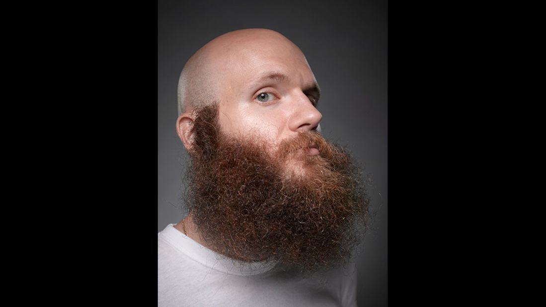 Care must be taken over the context in which the beard is presented -- in other words, the style of hair worn on the head. Devin Cara chooses to shave his pate in order to lend his impressive auburn beard maximum impact.