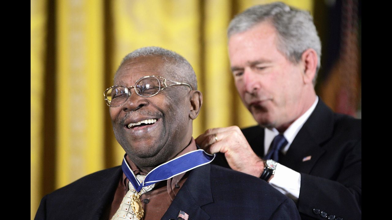 King smiles as President George W. Bush presents him with the Presidential Medal of Freedom during a White House ceremony in 2006.