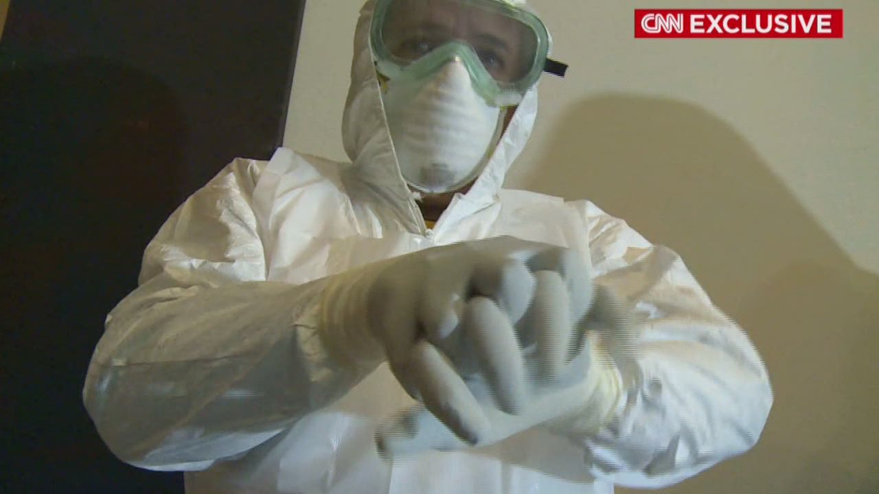 A Cuban doctor dons protective gear as part of his training