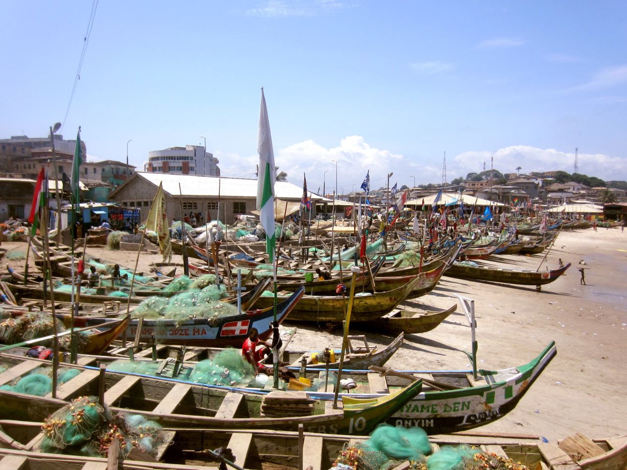 Small fishing boats line Elmina Beach in Cape Coast, Ghana. Two centuries ago, slave ships lined this same beach as they prepared for a long journey across the Atlantic.
