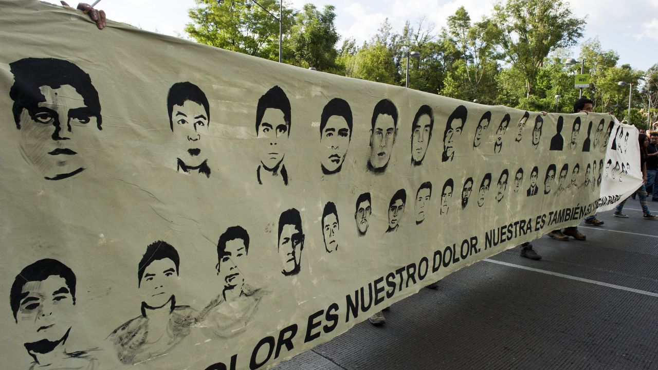 Protestors march with pictures of the missing students during a demostration in Mexico City on October 8, 2014, demanding justice in the case of the 43 students that went missing in Iguala, Guerrero state, last September 26, after a clash with local police. Thousands of people protested around the country on Wednesday amid fears the students were executed by a gang working with crooked police. AFP PHOTO/Hector Guerrero (Photo credit should read HECTOR GUERRERO/AFP/Getty Images)