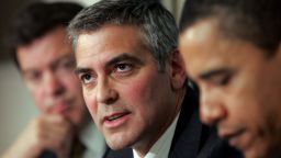 WASHINGTON - APRIL 27:  Actor George Clooney (C) answers a question during The National Press Club Newsmaker's Program April 27, 2006 in Washington, DC. Clooney joined Sen. Sam Brownback (L) (R-KS) and Sen. Barack Obama (R) (D-IL) in discussing the current situation in the Darfur region of Sudan and also held a news conference regarding Clooney's recent visit to the Darfur.  (Photo by Win McNamee/Getty Images)