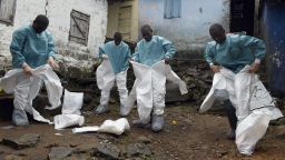 Medical staff members of the Croix Rouge NGO put on protective suits before collecting the corpse of a victim of Ebola, in Monrovia, on September 29, 2014. Of the four west African nations affected by the Ebola outbreak, Liberia has been hit the hardest, with 3,458 people infected -- more than half of the total number of cases. Of those, 1,830 have died, according to a WHO count released on September 27.