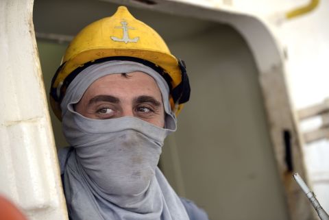 Here, a Ukrainian sailor uses a T-shirt as a face mask as he watches Nigerian health workers check the ship he's on for signs of the Ebola virus. The World Health Organization, or WHO, recommends a medical mask to adequately protect the mouth and nose.