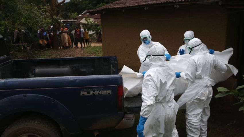 A burial team from the Liberian Red Cross carries the body of an Ebola victim from his home on October 8, 2014 near Monrovia, Liberia. The Ebola epidemic has killed more than 3,400 people in West Africa, according to the World Health Organization.