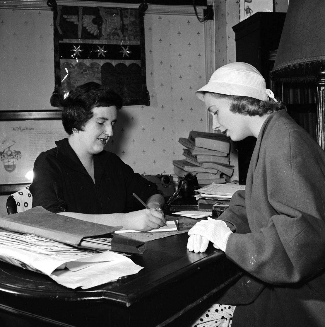 July, 1956: A woman traces her family tree in the UK Public Record Office.