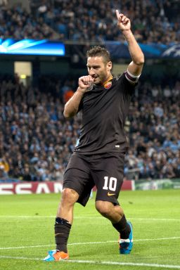 Roma's Italian forward Francesco Totti celebrates scoring against Manchester City 2014.