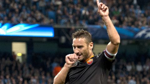 Roma's Italian forward Francesco Totti celebrates scoring against Manchester City 2014.