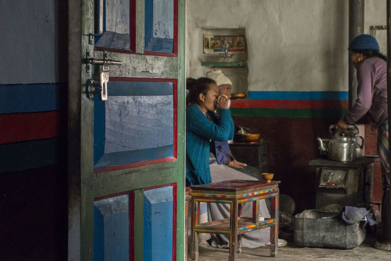 Staying in a local home is a meaningful way to generate cultural exchange out of brief encounters. Dikee Dolker Gurung, 30, and her parents Angjuk Gurung, 71, and Tsering Pajung Gurung, 62, eat breakfast around the stove.