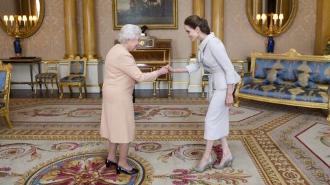 Angelina Jolie meets Queen Elizabeth as she is presented with the Insignia of an Honorary Dame Grand Cross of the Most Distinguished Order of St. Michael and St. George at Buckingham Palace on Friday.