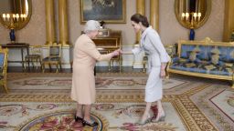 U.S actress Angelina Jolie, right, is presented with the Insignia of an Honorary Dame Grand Cross of the Most Distinguished Order of St Michael and St George by Britain's Queen Elizabeth II at Buckingham Palace, London, Friday, Oct. 10, 2014. Jolie received an honorary damehood (DCMG) for services to UK foreign policy and the campaign to end war zone sexual violence. (AP Photo/Anthony Devlin, pool)