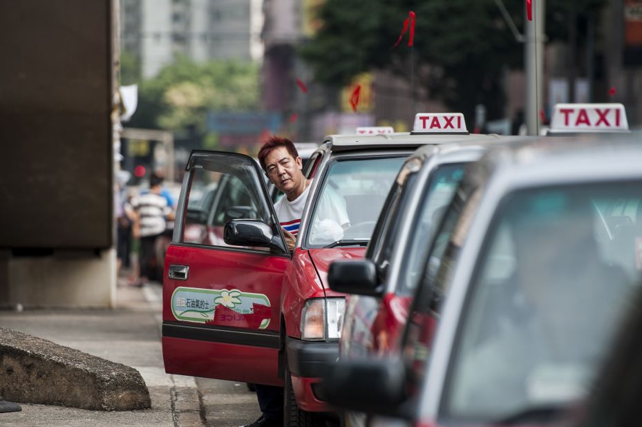 Taxi drivers attend a small demonstration calling for protesters to stop blocking roads through the city on October 9.