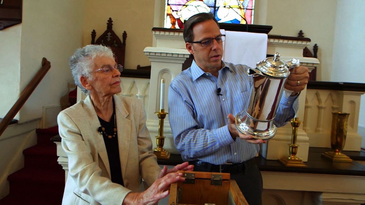Tapper examines a silver communion tankard dedicated to ancestor Englebert Huff at the First Reformed Church of Fishkill. The inscription on the tankard says Huff lived to the age of 128. Skinner said he probably did not live that long but he lived a fascinating life.