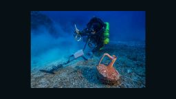 Greek technical diver Alexandros Sotiriou discovers an intact "lagynos" ceramic table jug and a bronze rigging ring on the Antikythera shipwreck.