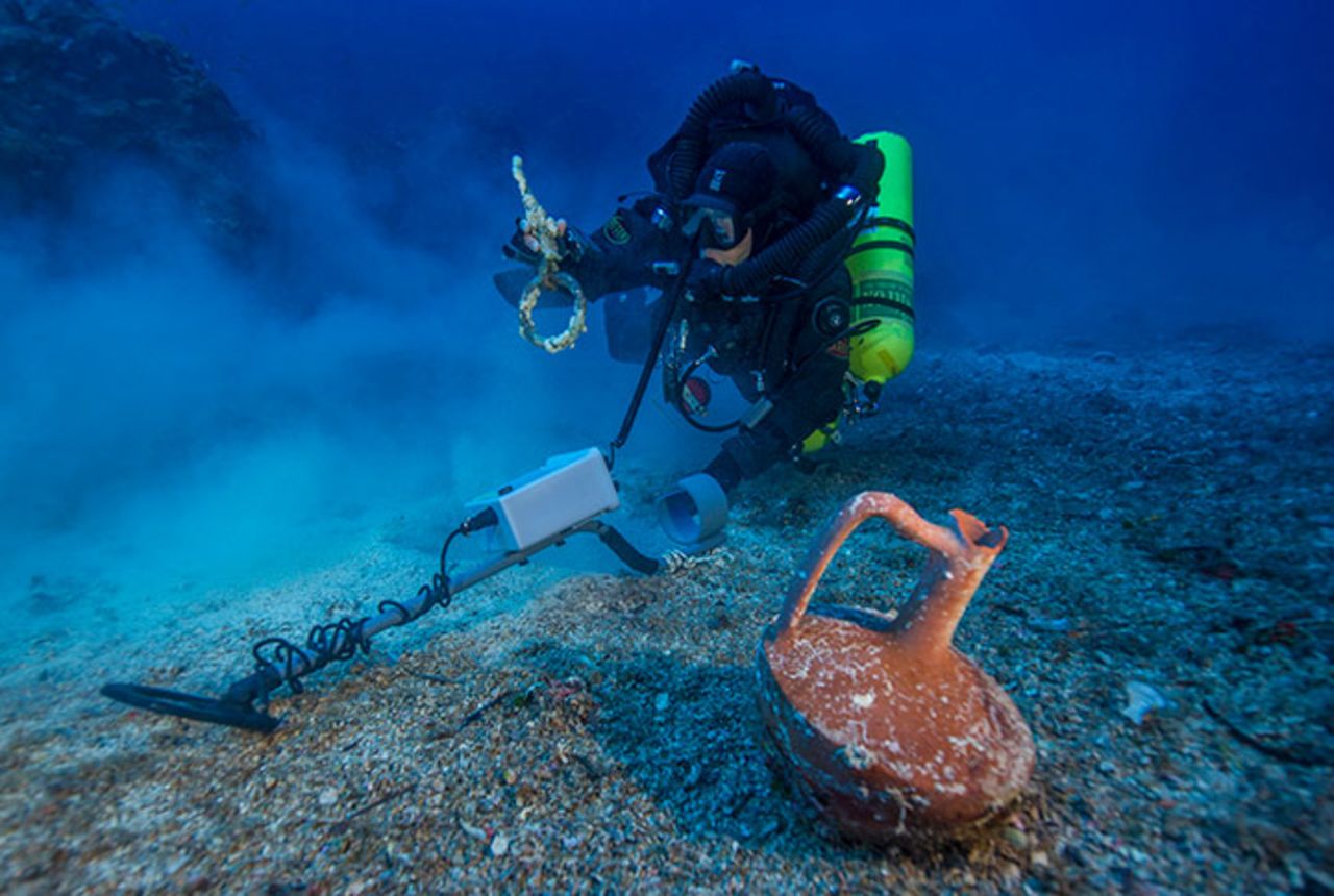 After spending the last month at the historic wreck site, the <a href="http://www.whoi.edu/news-release/antikythera-finds" target="_blank" target="_blank">Woods Hole Oceanographic Institute</a> (WHOI) announced that an international team of archaeologists had recovered new items from the Antikythera wreck. Pictured, Greek technical diver Alexandros Sotiriou discovers an intact "lagynos" ceramic table jug and a bronze rigging ring. The new items have indicated the wreck site is much bigger than previously believed, scattered across 300 meters of seafloor.