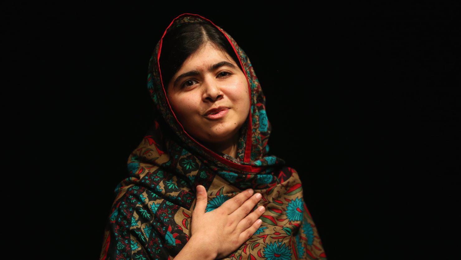 Malala Yousafzai acknowledges the crowd at a press conference at the Library of Birmingham after being announced as a recipient of the Nobel Peace Prize
