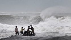 Indian fishermen negotiate their skiff through rough waves ahead of Cyclone Hudhud making expected landfall in Visakhapatnam on October 11, 2014. India on October 11 began evacuating thousands of people from fishing villages as it braced for Cyclone Hudhud barrelling towards its east coast, officials said. AFP PHOTO/STR (Photo credit should read STRDEL/AFP/Getty Images)