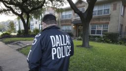 CORRECTS BYLINE - Police stand guard outside the apartment of a hospital worker, Sunday, Oct. 12, 2014, in Dallas. The Texas health care worker, who was in full protective gear when they provided hospital care for Ebola patient Thomas Eric Duncan, who later died, has tested positive for the virus and is in stable condition, health officials said Sunday. (AP Photo/LM Otero)