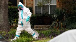 Caption:DALLAS, TX - OCTOBER 12: A man dressed in protective hazmat clothing walks towards an apartment where a second person diagnosed with the Ebola virus resides on October 12, 2014 in Dallas, Texas. A female nurse working at Texas Heath Presbyterian Hospital, the same facility that treated Thomas Eric Duncan, has tested positive for the virus. (Photo by Mike Stone/Getty Images)