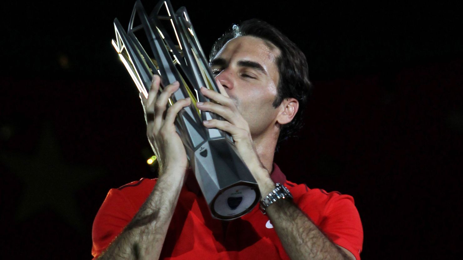 Sealed with a kiss: Roger Federer wins his first Shanghai Masters and fourth title of the 2014 season