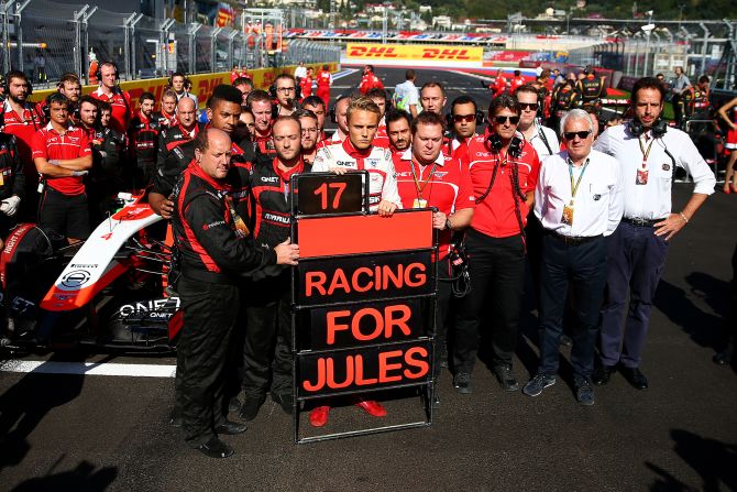 Marussia has not just been troubled by financial problems this season, with the team left devastated after French driver Jules Bianchi crashed and suffered critical head injuries at the Japanese Grand Prix. Here Chilton stands with his team next to a tribute to Bianchi and Marussia following his accident at Suzuka during the Russian Grand Prix at Sochi in October.