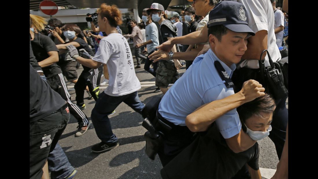 A police officer scuffles with a man on October 13.