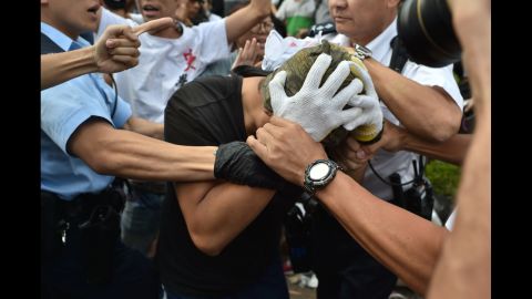 Police officers arrest a demonstrator on October 13.