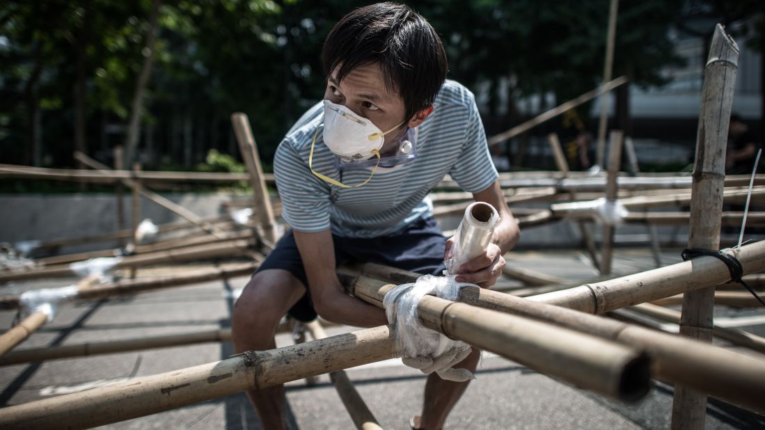 A demonstrator sets up a new barricade made of bamboo in Hong Kong on October 13.
