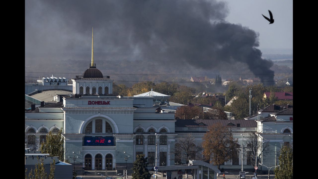 Smoke rises behind the train station in Donetsk, Ukraine, during an artillery battle between pro-Russian rebels and Ukrainian government forces on Sunday, October 12.