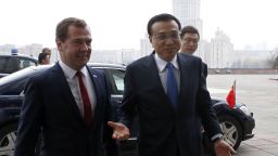 Russia's Prime Minister Dmitry Medvedev (R) welcomes China's Prime Minister Li Keqiang before a meeting in Moscow, on October 13, 2014. AFP PHOTO/RIA-NOVOSTI/POOL/DMITRY ASTAKHOV (Photo credit should read DMITRY ASTAKHOV/AFP/Getty Images)