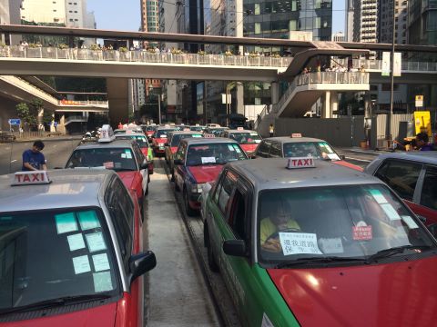 Taxi drivers protest in Hong Kong on October 13, urging pro-democracy demonstrators to clear the roads.