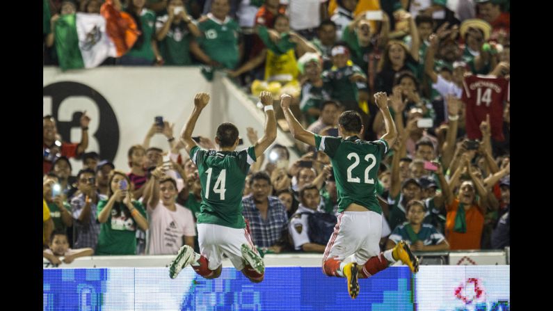Mexican soccer players Javier Hernandez, left, and Paul Aguilar celebrate after Hernandez scored against Honduras during an international friendly match Thursday, October 9, in Tuxtla Gutierrez, Mexico. Mexico won 2-0.