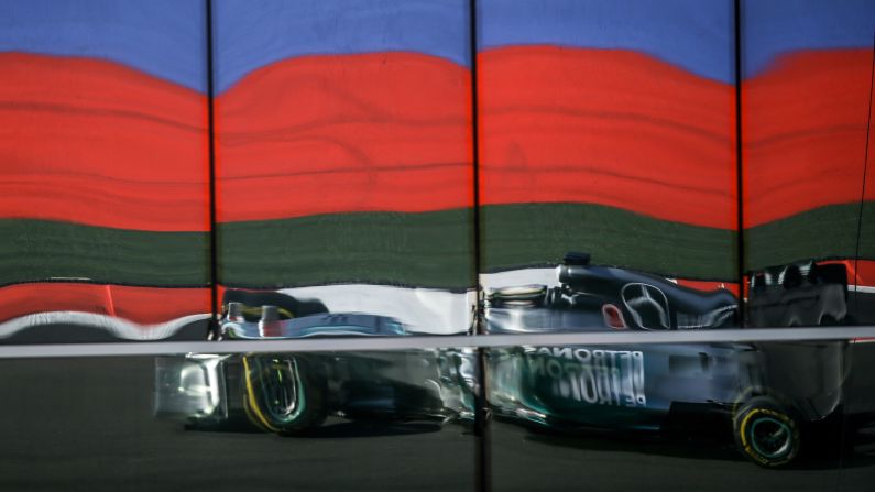 The reflection of Formula One driver Lewis Hamilton is seen Sunday, October 12, as he competes in the Russian Grand Prix in Sochi, Russia. Hamilton won the race to stay atop the drivers' standings. He has now won nine races this season and four in a row.