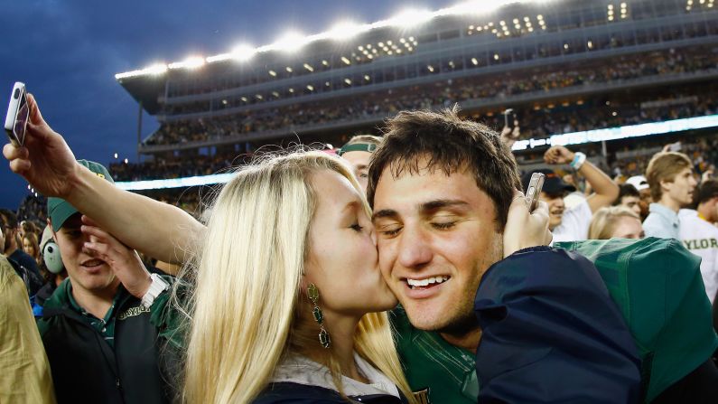 Baylor's Chris Callahan receives a kiss from Grace Dille after he kicked the game-winning field goal to beat TCU on Saturday, October 11, in Waco, Texas. Baylor trailed by three touchdowns in the fourth quarter but rallied to win 61-58.