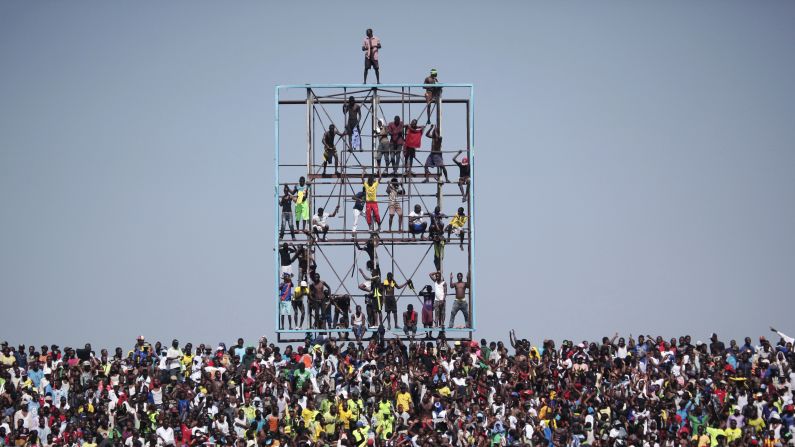 Soccer fans in Kinshasa, the capital city of the Democratic Republic of Congo, climb a scoreboard Saturday, October 11, to watch their national team play Ivory Coast in a qualifying match for the African Cup of Nations. Ivory Coast won 2-1.