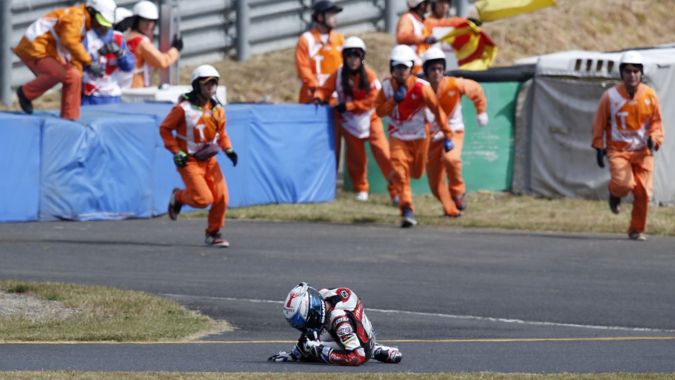 Course marshals in Tokyo run toward Moto3 rider Miguel Oliveira after he fell off his motorcycle during the Japanese Grand Prix on Sunday, October 12. He was not seriously hurt.