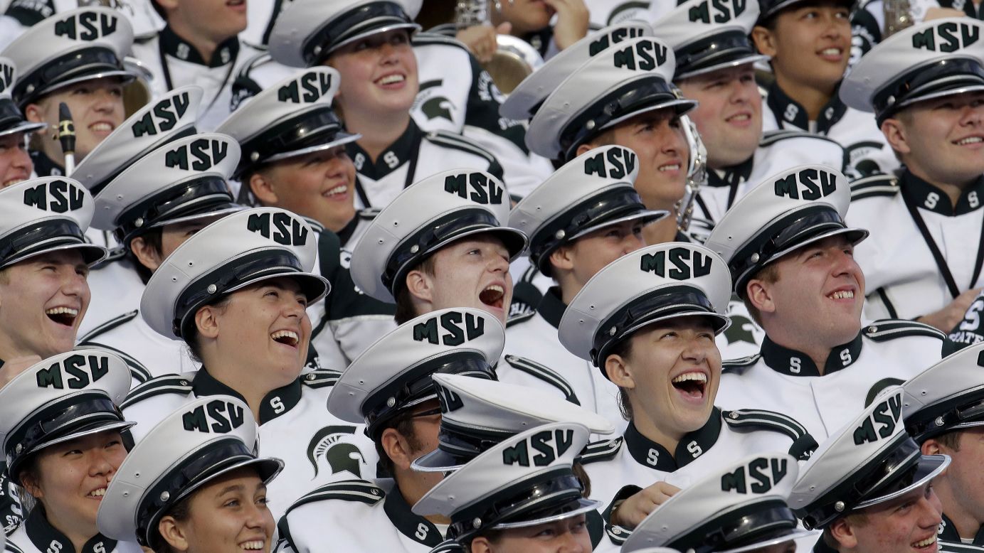 Members of the Michigan State marching band laugh while watching a video at Purdue's stadium during a timeout Saturday, October 11, in West Lafayette, Indiana.