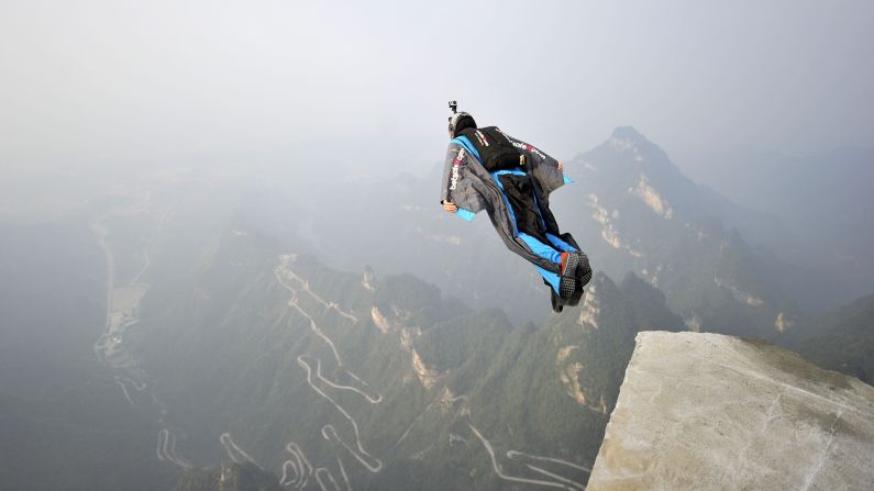 A wingsuit flier jumps from China's Tianmen Mountain during practice for the Red Bull World Wingsuit League on Saturday, October 11.