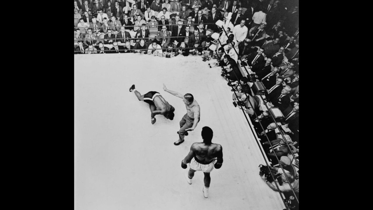 The referee pushes Ali to a neutral corner as Floyd Patterson slumps to the canvas in November 1965. The fight was stopped at the end of the 12th round and Ali was declared the winner.