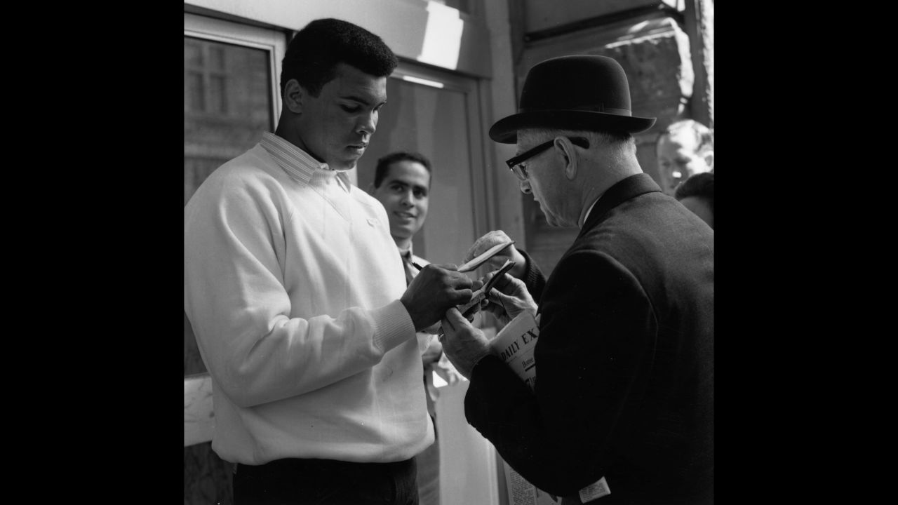 Ali signs an autograph for a fan in 1966.