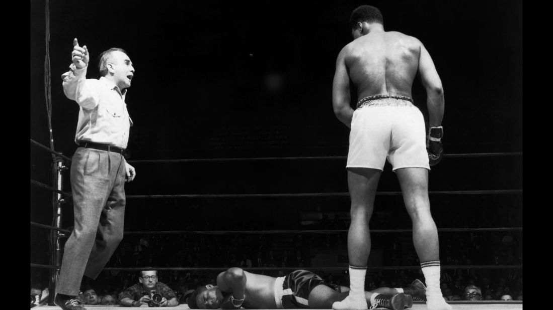 The referee counts as Ali looks down at Zora Folley during a championship fight in New York on March 23, 1967. Ali won by a knockout in the seventh round.