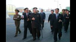 Photos released today, from an unknown shot date, show North Korea's leader, Kim Jong Un with other officials, using a cane.