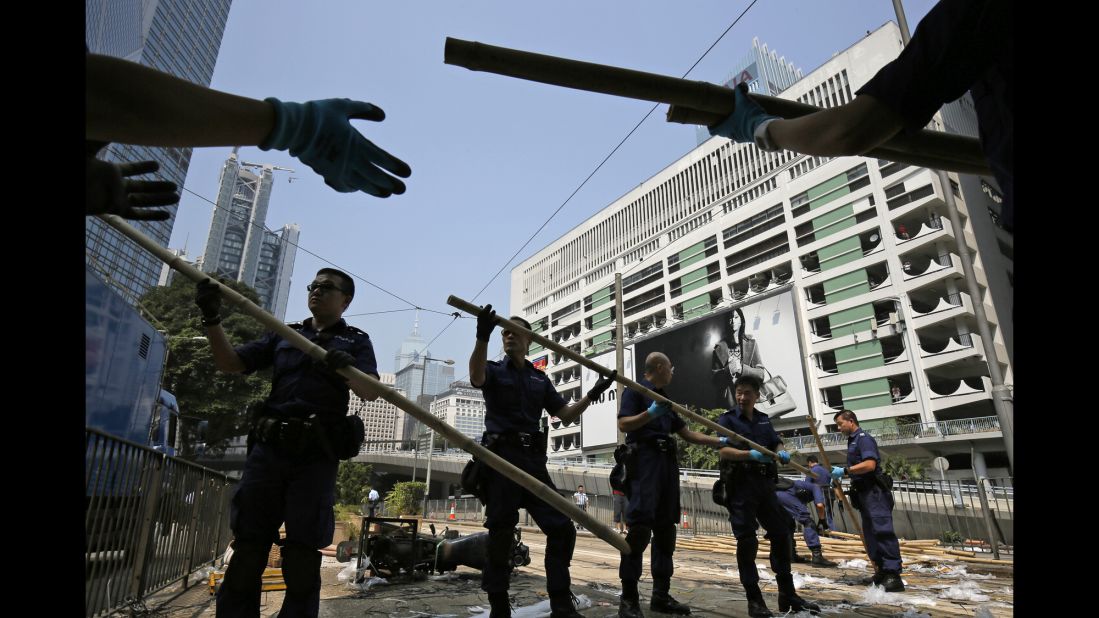 Police remove bamboo that pro-democracy protesters had set up to block off main roads on October 14. 